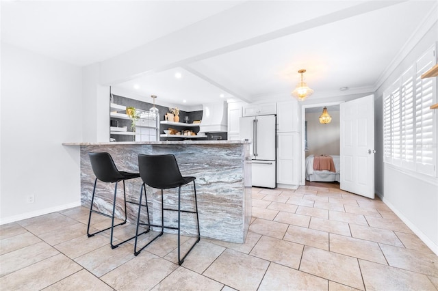 kitchen with a breakfast bar area, white cabinetry, paneled built in fridge, custom range hood, and kitchen peninsula