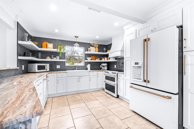 kitchen with premium range hood, backsplash, hanging light fixtures, high quality appliances, and white cabinets