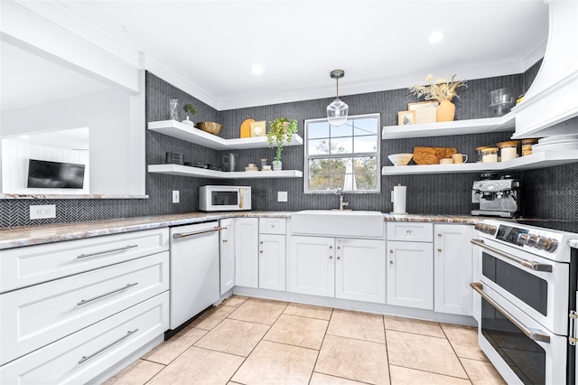 kitchen featuring tasteful backsplash, sink, white cabinets, hanging light fixtures, and white appliances