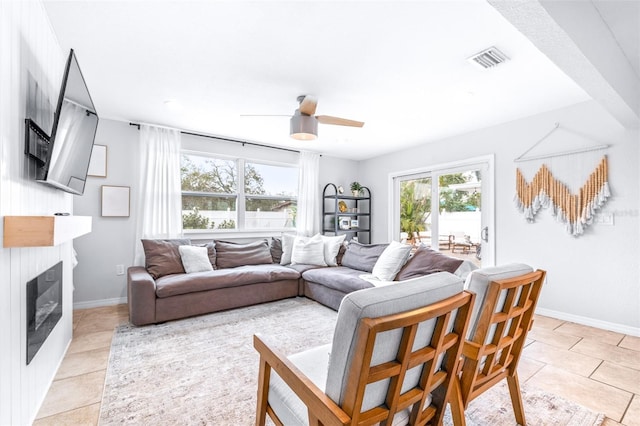 living room featuring light tile patterned floors and ceiling fan