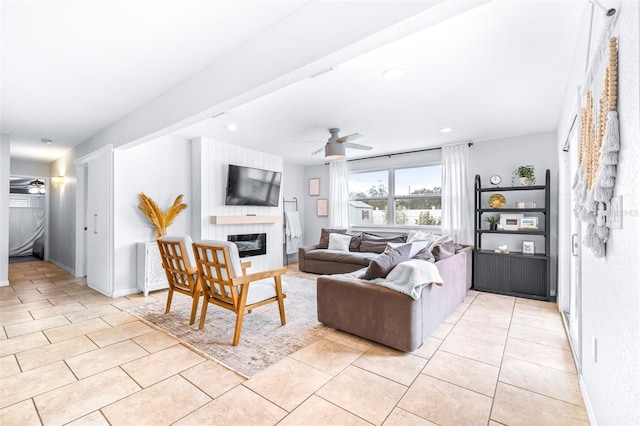 living room with ceiling fan and light tile patterned floors