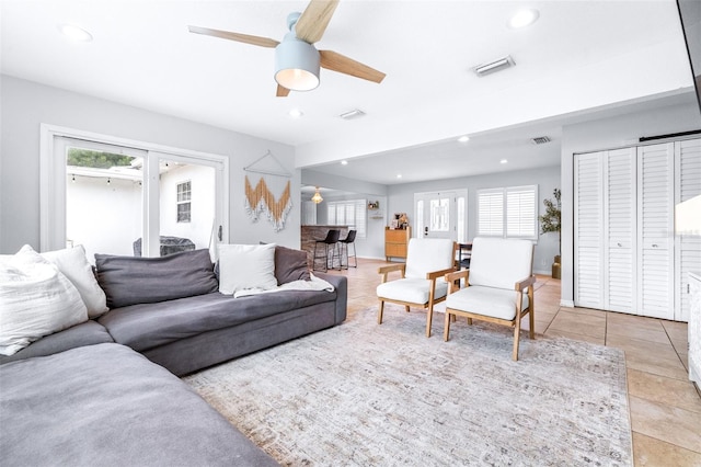 living room with light tile patterned flooring and ceiling fan