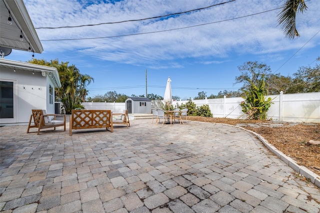 view of patio with a storage shed