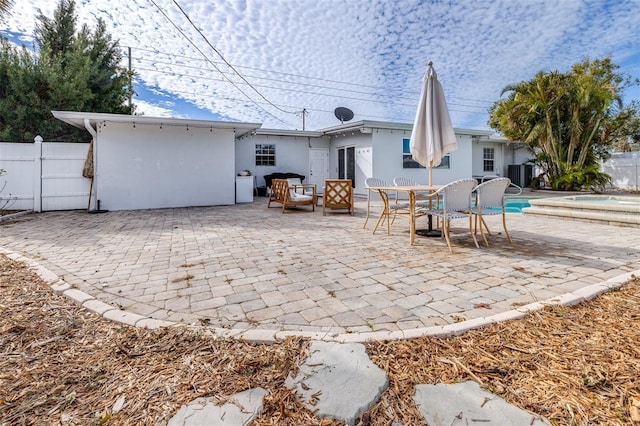 rear view of property with a fenced in pool, a patio, and central AC unit