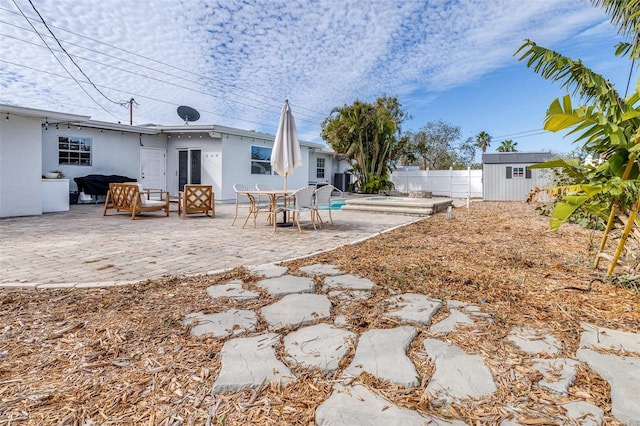 view of yard with a storage unit and a patio area