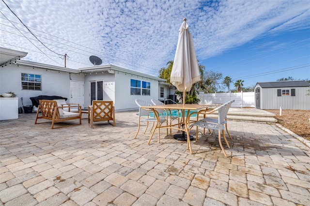 view of patio featuring an outdoor hangout area and a storage unit