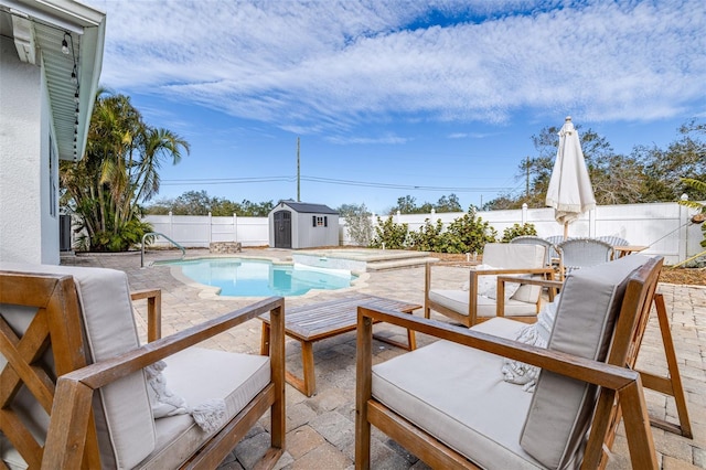 view of swimming pool with a storage shed and a patio area