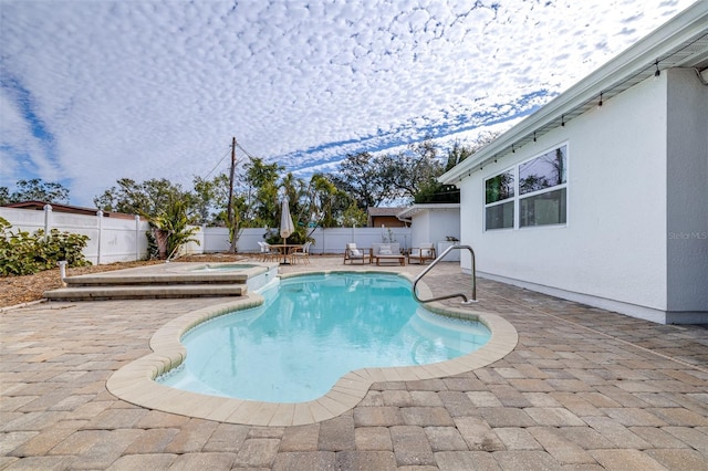 view of pool featuring an in ground hot tub and a patio area