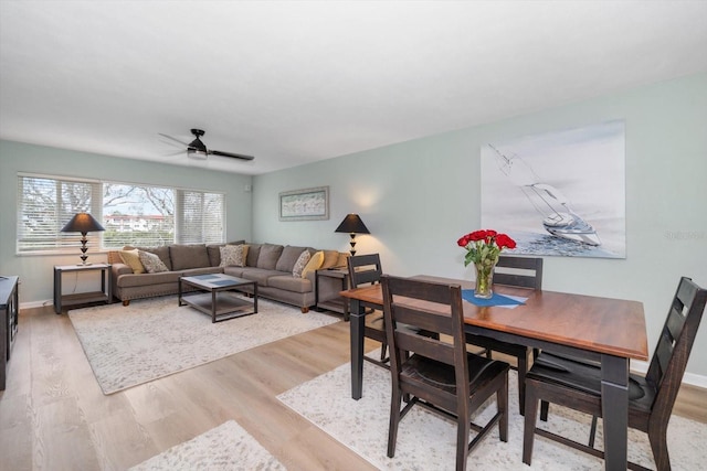 living room with ceiling fan and light wood-type flooring