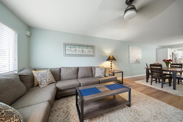 living room featuring ceiling fan, plenty of natural light, and hardwood / wood-style floors