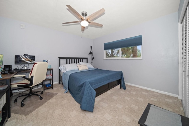 carpeted bedroom with ceiling fan and a closet