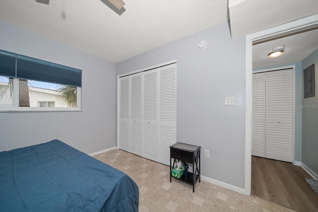 bedroom with ceiling fan and electric panel