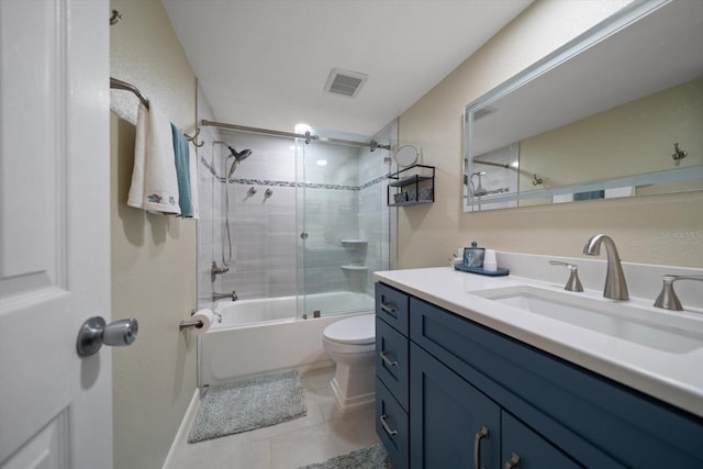 full bathroom with vanity, tile patterned flooring, toilet, and combined bath / shower with glass door