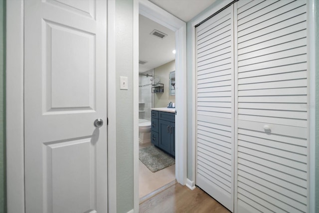 hallway with light hardwood / wood-style flooring