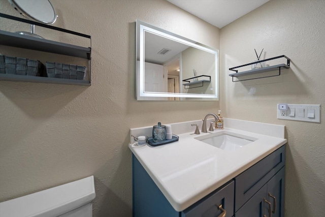 bathroom featuring vanity and toilet