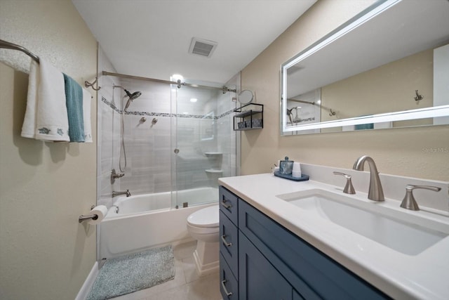 full bathroom featuring vanity, tile patterned floors, enclosed tub / shower combo, and toilet