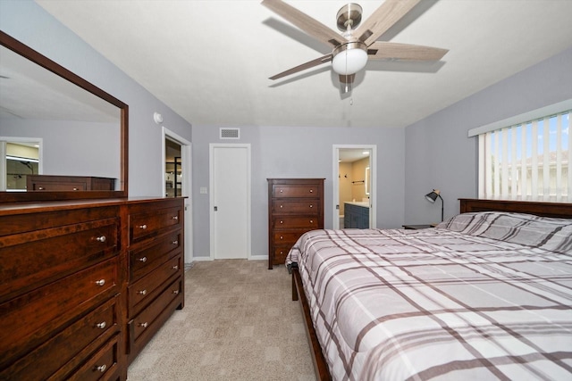 carpeted bedroom with ceiling fan and ensuite bathroom