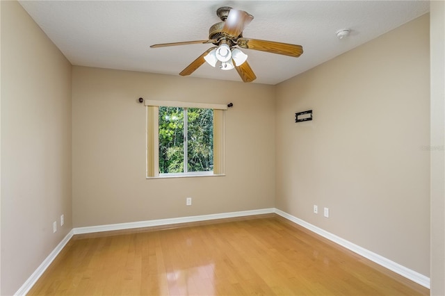 empty room featuring ceiling fan and light hardwood / wood-style floors