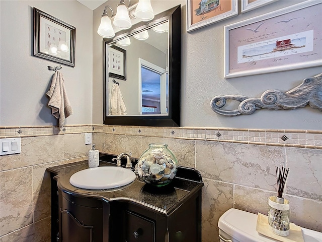 bathroom featuring tile walls, vanity, and toilet