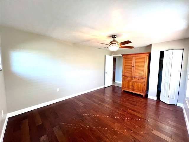 unfurnished bedroom with dark wood-type flooring and ceiling fan