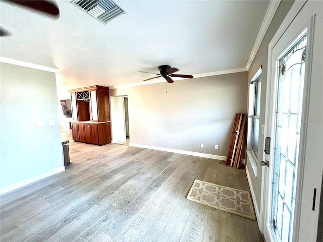 unfurnished living room featuring crown molding, ceiling fan, and light hardwood / wood-style floors