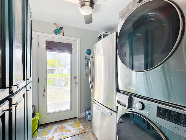 washroom featuring stacked washer and dryer and ceiling fan