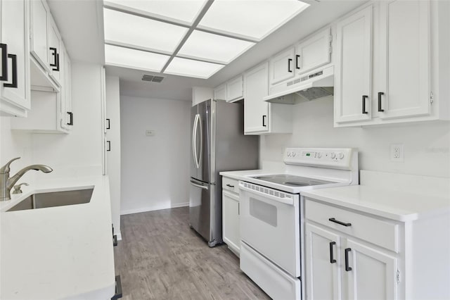 kitchen featuring sink, stainless steel fridge, white cabinets, light hardwood / wood-style floors, and electric stove