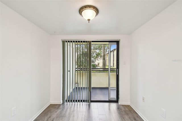 spare room with wood-type flooring