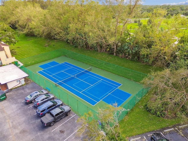 view of sport court featuring a lawn