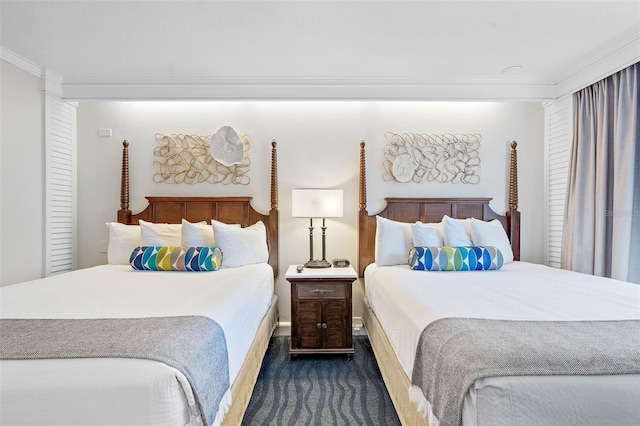 bedroom featuring ornamental molding and dark colored carpet