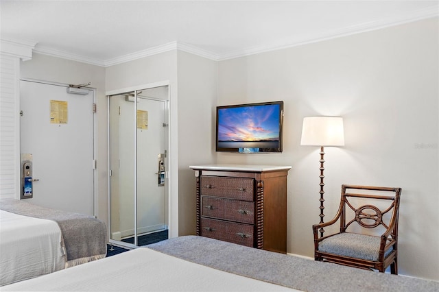 bedroom with ornamental molding and a closet