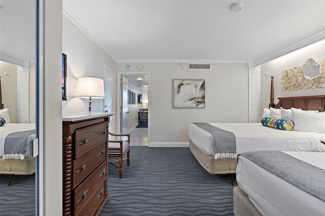 bedroom with crown molding and dark colored carpet