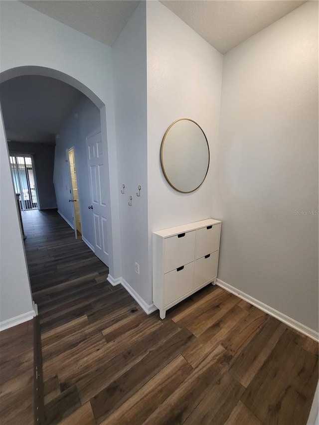 hallway with dark wood-type flooring