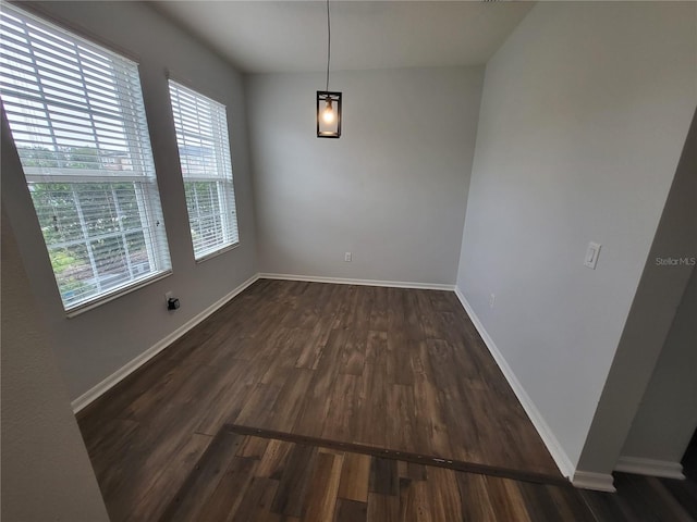 unfurnished dining area featuring dark hardwood / wood-style flooring