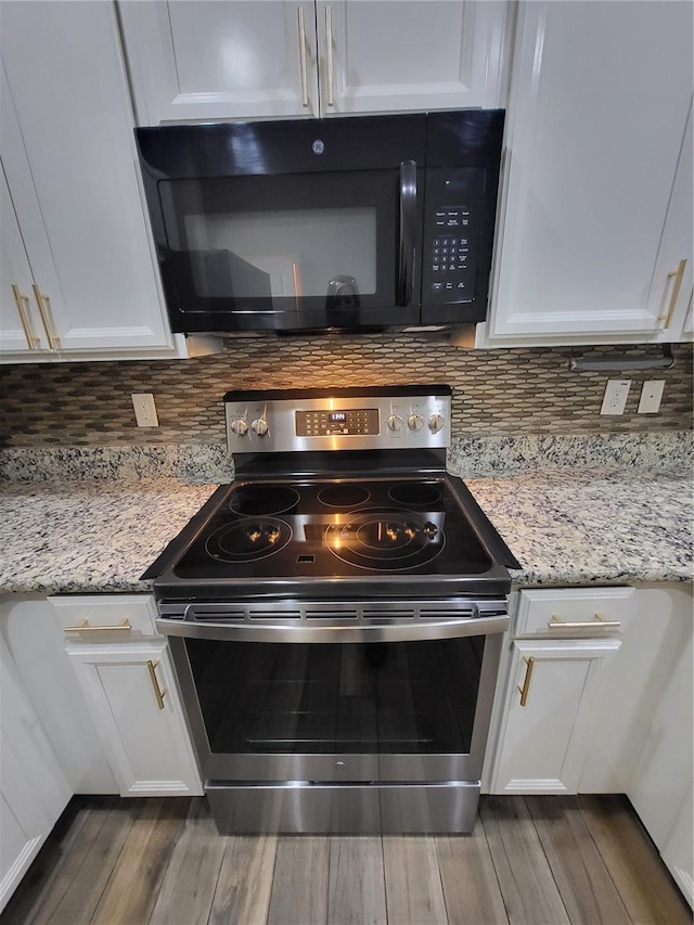 kitchen featuring white cabinetry, hardwood / wood-style floors, tasteful backsplash, light stone countertops, and stainless steel range with electric cooktop