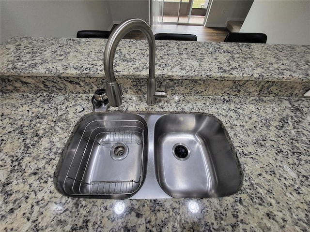 details featuring stone countertops and sink