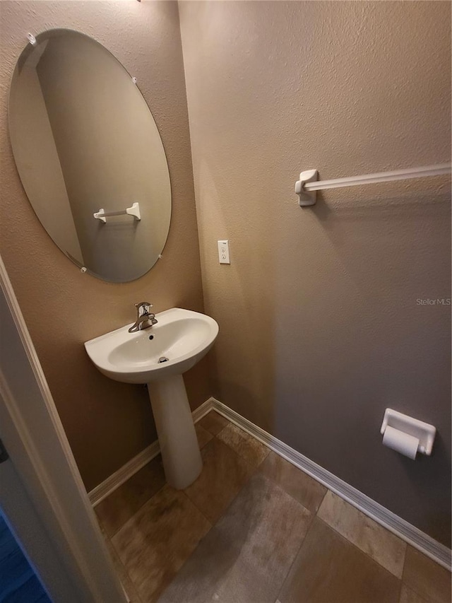 bathroom with sink and tile patterned flooring