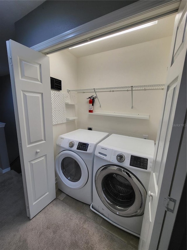 washroom featuring light carpet and independent washer and dryer