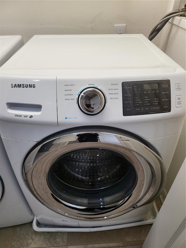 clothes washing area with washer / dryer