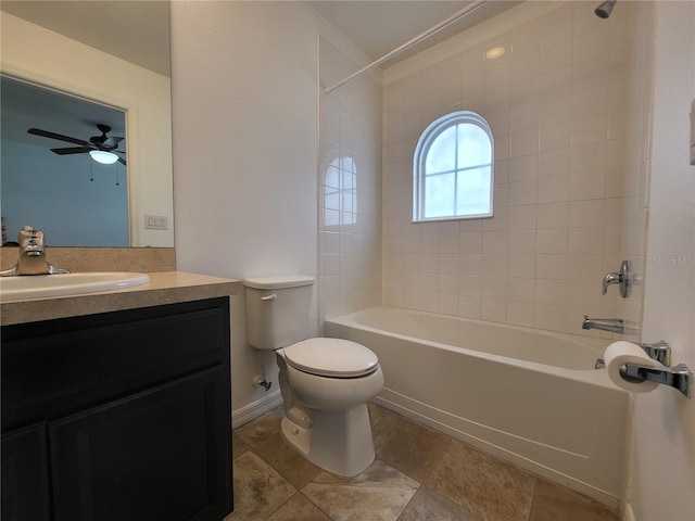 full bathroom with ceiling fan, tiled shower / bath, vanity, and toilet