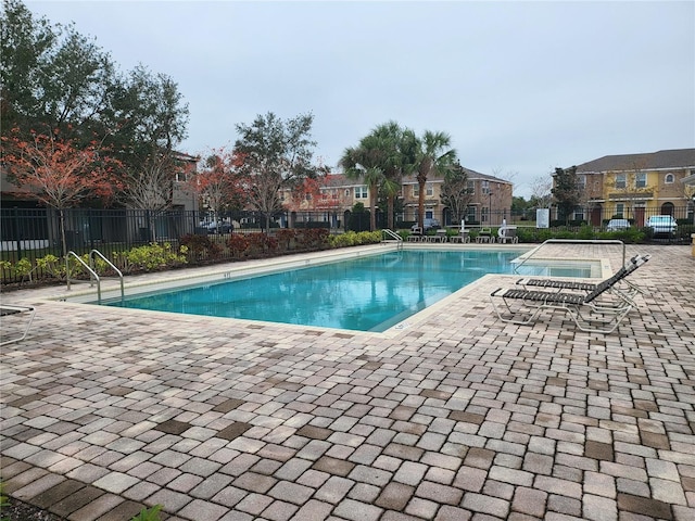 view of swimming pool with a jacuzzi and a patio