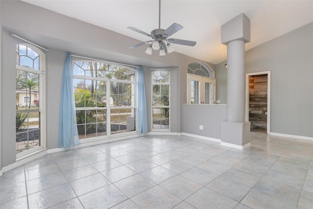 interior space with ceiling fan, plenty of natural light, lofted ceiling, and ornate columns