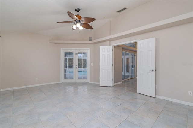 spare room with lofted ceiling, light tile patterned floors, ceiling fan, and french doors