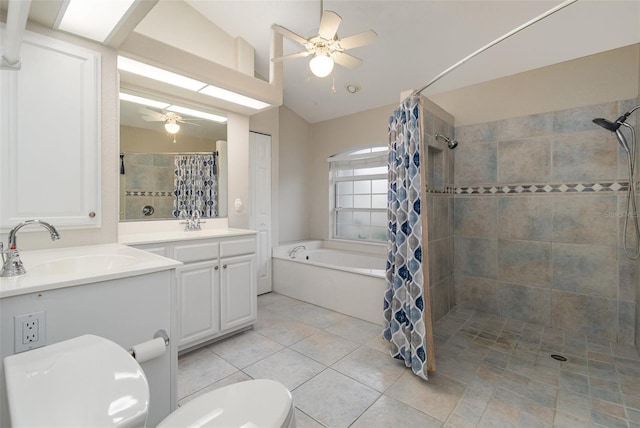 bathroom with lofted ceiling, ceiling fan, tile patterned flooring, vanity, and toilet