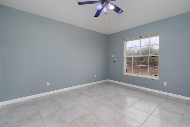 tiled empty room featuring ceiling fan