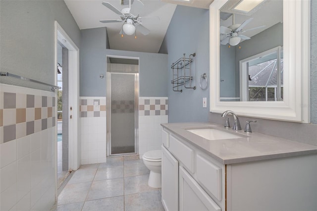 bathroom featuring walk in shower, tile patterned floors, toilet, and vanity