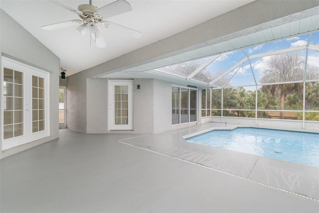 view of swimming pool featuring a lanai, a patio area, and french doors