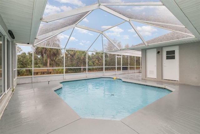 view of swimming pool with a lanai and a patio