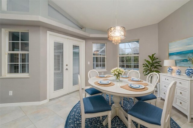 5366 Hader Rd, North Port, FL 34288 - dining room with an inviting chandelier, lofted ceiling, baseboards, french doors, and light tile patterned floors