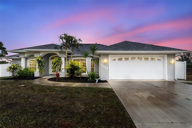 5366 Hader Rd, North Port, FL 34288 - ranch-style house featuring a garage, fence, stucco siding, and driveway